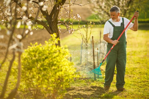 Gardener wearing PPE while operating a powered tool